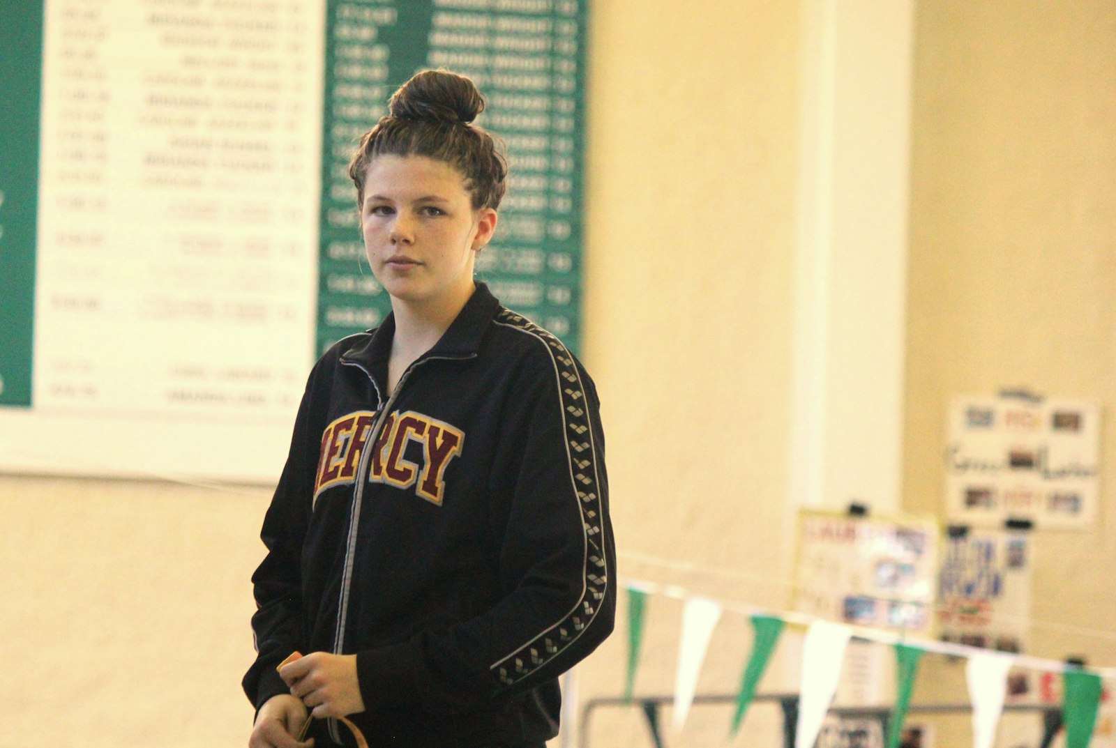 Mercy freshman Emilia Coccia receives her award for finishing fourth in the breaststroke. Her time of 1:11.75 enabled her to qualify for the state championship meet next weekend.