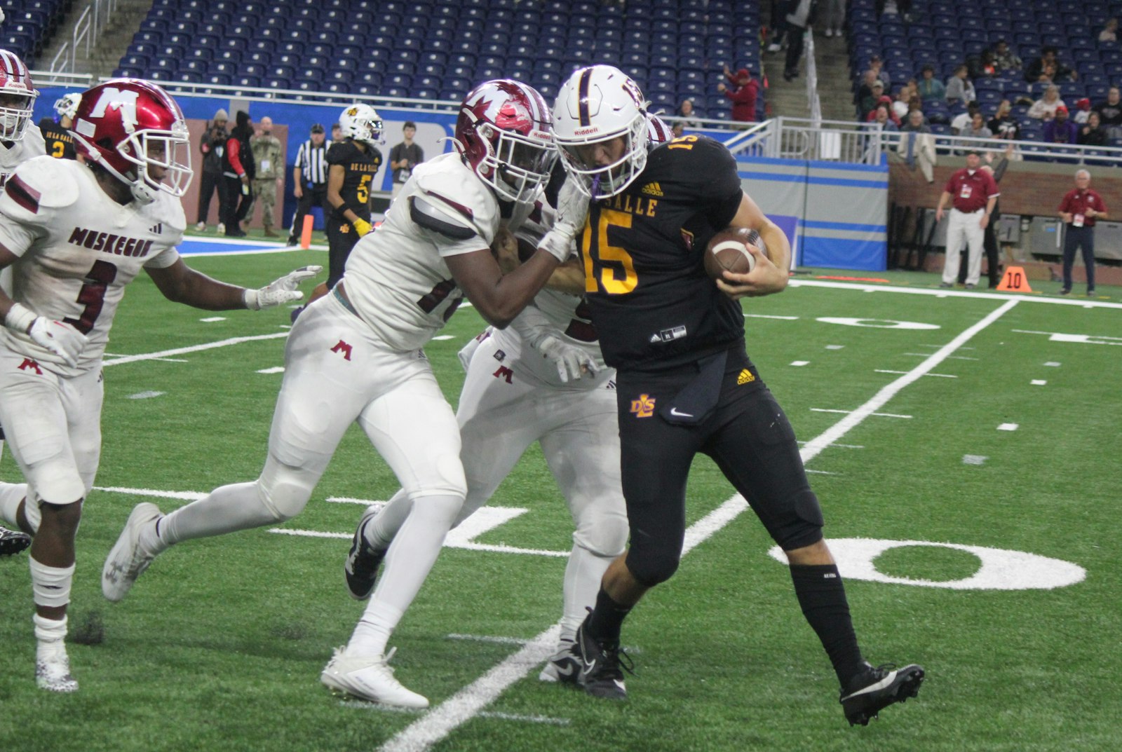 On the final play of the game, De La Salle quarterback Sante Gasperoni is stopped shy of the end zone by Muskegon’s M’Khi Guy, Stanley Cunningham and Chris Jones. (Photo by Wright Wilson | Special to Detroit Catholic)