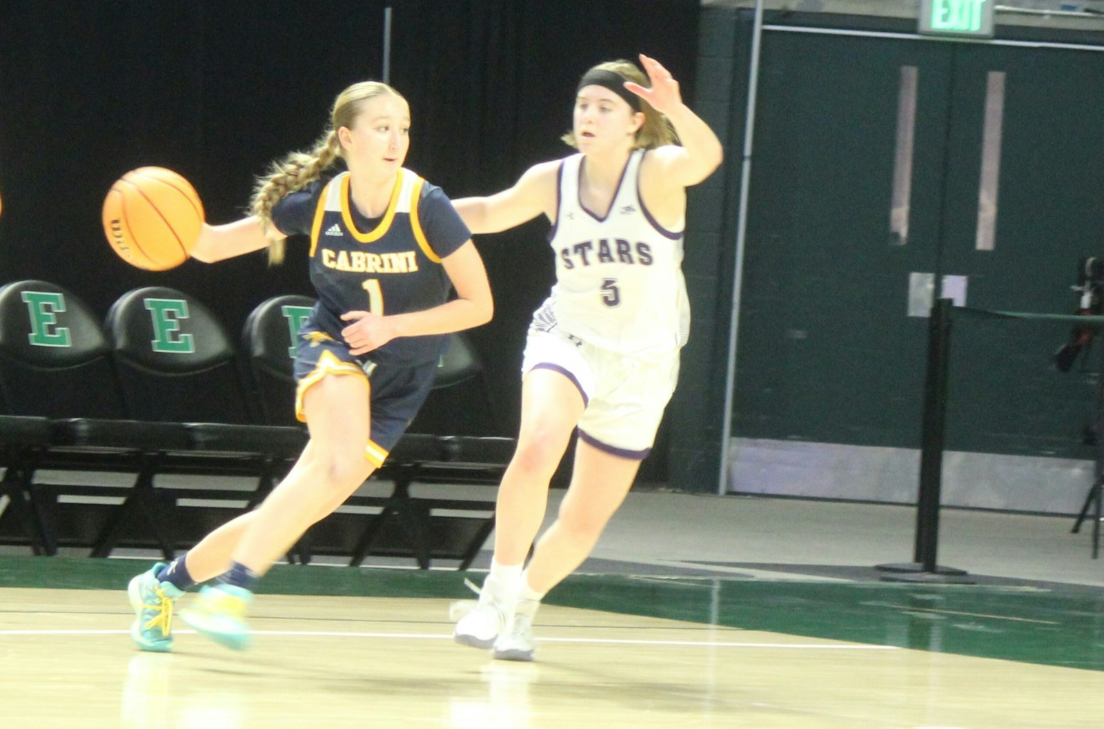 Allen Park Cabrini’s Madi Smith tries to move past Wixom St. Catherine’s Lauren Smith in the CHSL’s Cardinal Division final. St. Catherine opened up a big lead in the third quarter en route to a 67-41 victory.