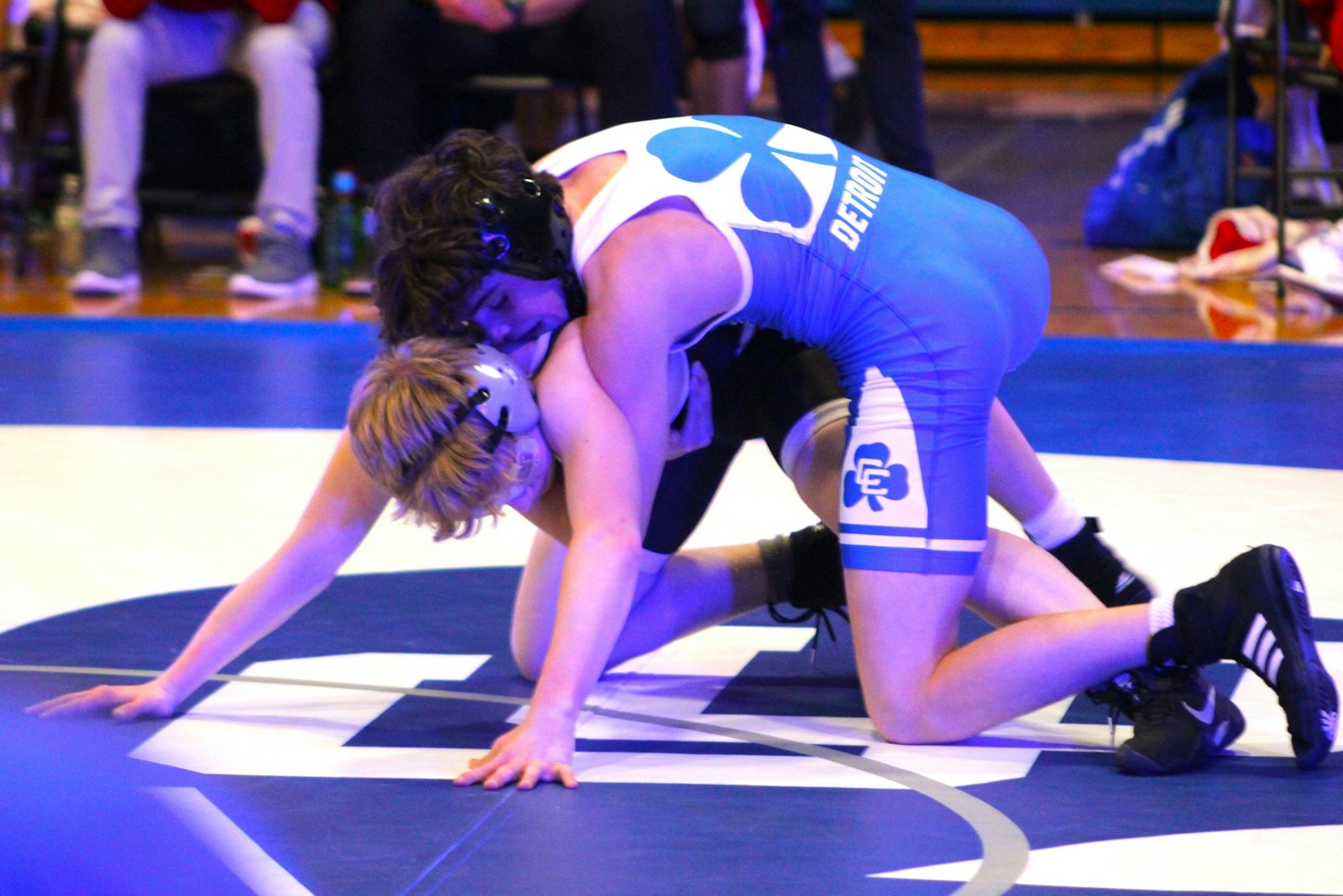 Catholic Central’s Grayson Fuchs rides Lowell’s Connor Cichocki on the way to winning his 124-pound match, giving the Shamrocks an early 21-6 lead over the Red Arrows.
