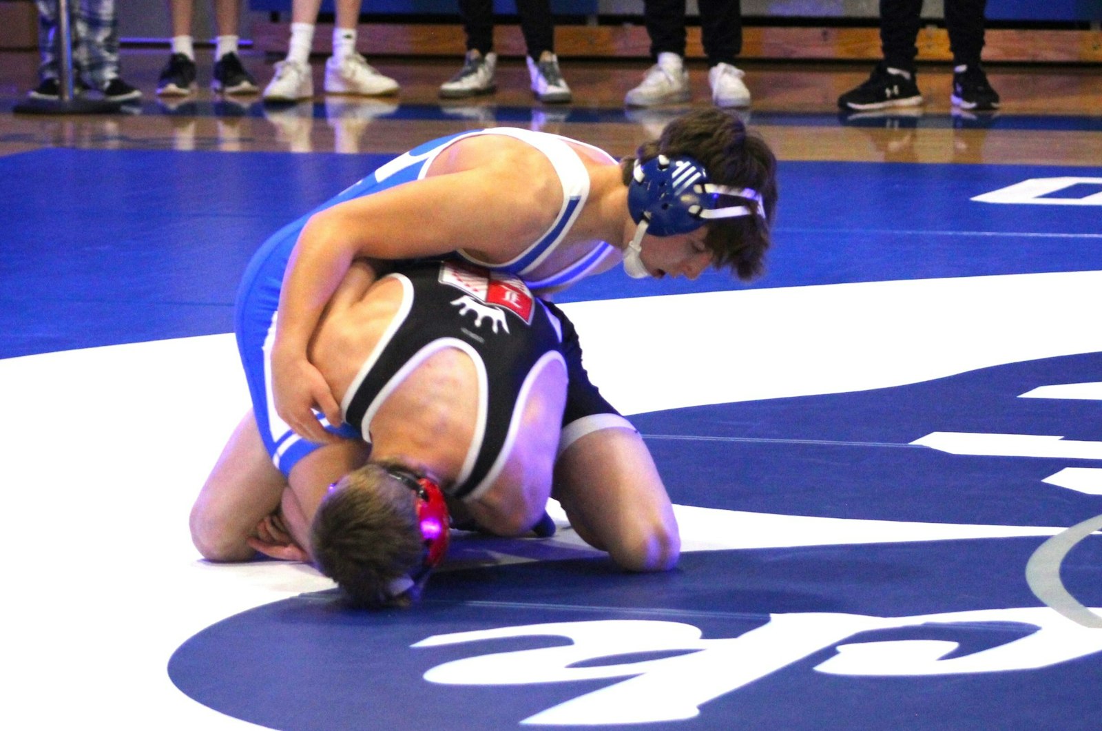 Catholic Central’s Drew Brewer attempts to roll Lowell’s Trevor Boone on to his back during the 144-pound bout.