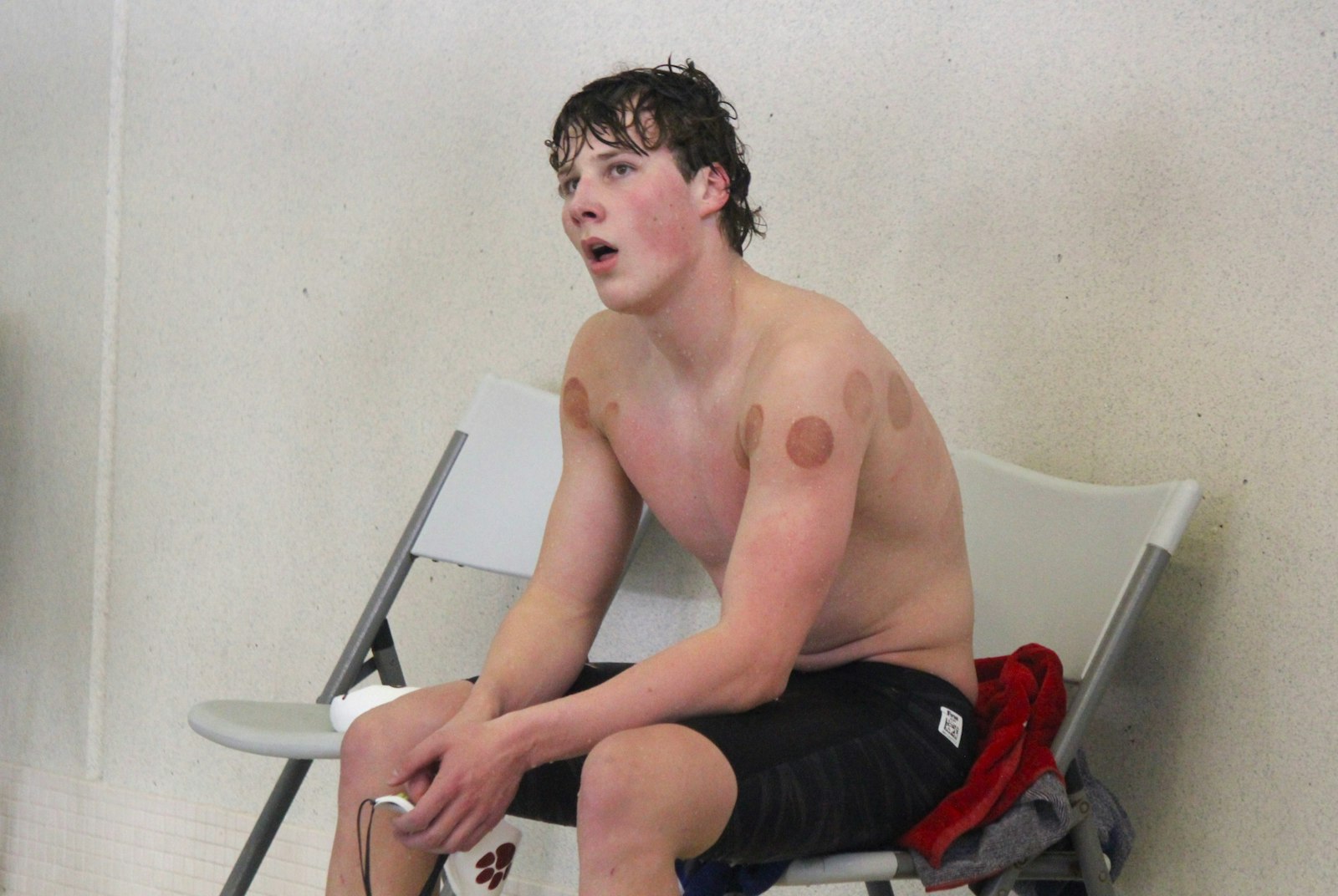 University of Detroit Jesuit’s Evan Tack catches his breath after a race. Tack set a Catholic League record in the individual medley (1:50.88) and later won the butterfly (50.00).