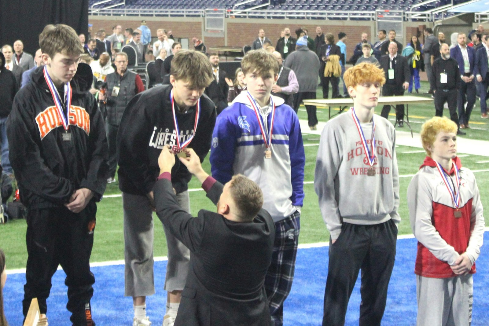 During the awards ceremony, Riverview Gabriel Richard head coach Derek Zambon presents the Division 4, 106-pound class gold medal to his son, Jordan. It was Jordan’s first title after finishing as runner-up last year as a freshman.