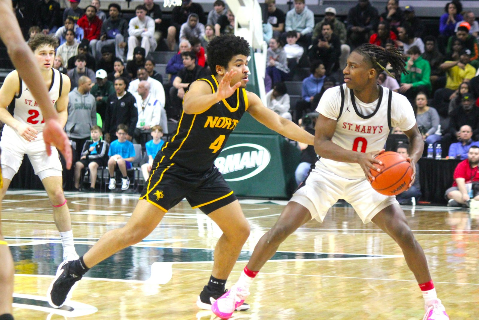 Sharod Barnes is guarded by North Farmington’s D.J. Morgan while Barnes looks to pass to Eaglet teammate Andrew Smith.