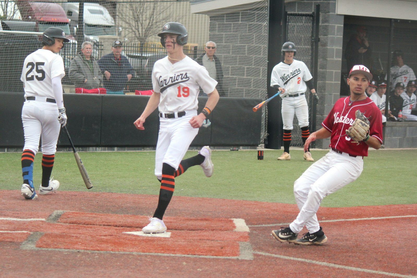 Chase VanAmeyde scores the go-ahead run in the bottom of the fifth inning to give Brother Rice a 4-3 lead against Detroit Western. The Warriors went on to score nine more times and end the game early.
