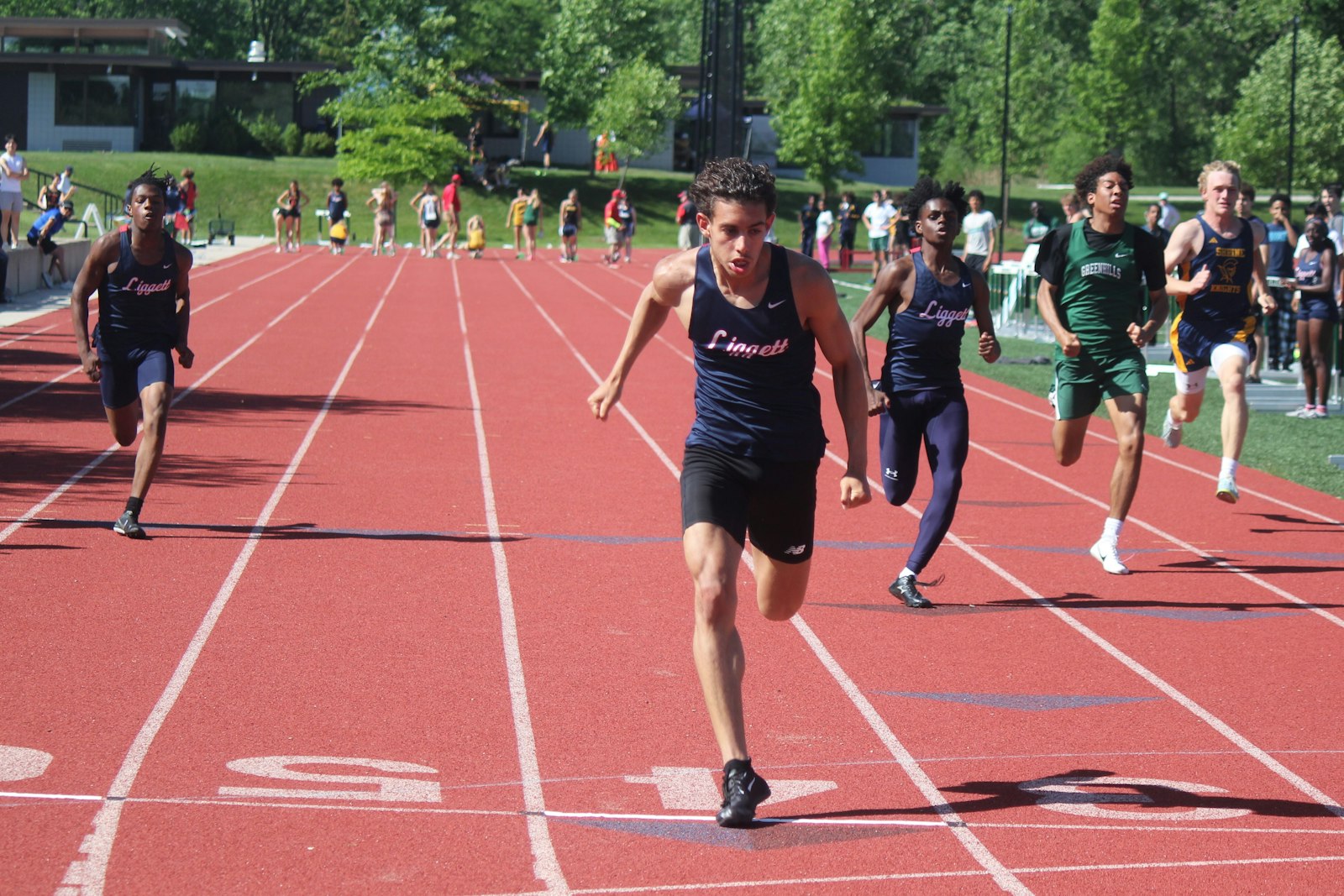 With teammates James McCullough and Pierre Walker II to the left and right, Grosse Pointe Woods University-Liggett’s Santino Cicarella wins the 100-meter dash. He also finished first in the 200 and 400 dashes.