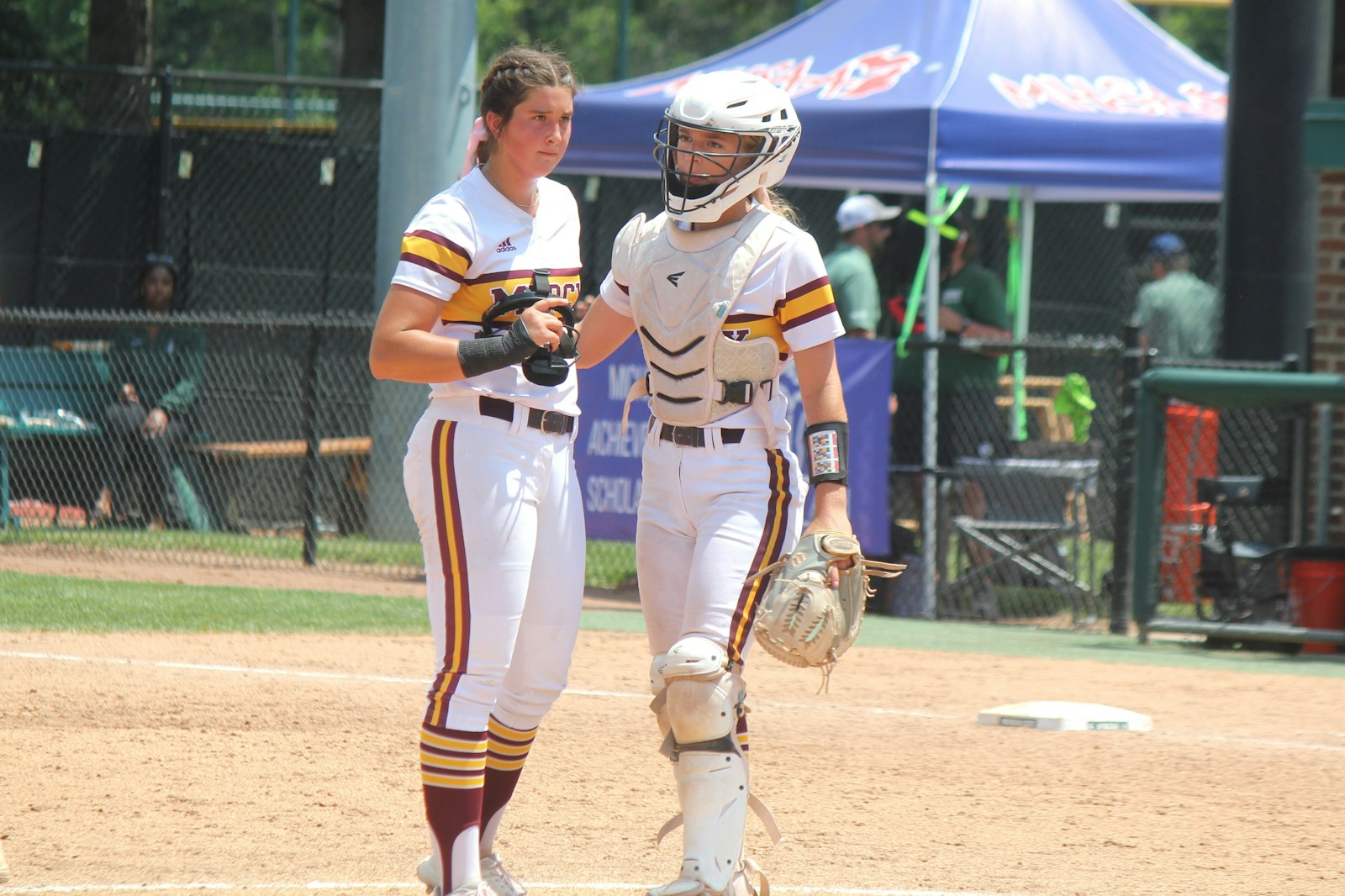 Catcher Kat Burras tries to calm down pitcher Kaitlyn Pallozzi following a Hudsonville home run in the sixth inning. Mercy allowed seven runs in the fifth inning and three more in the following frame.