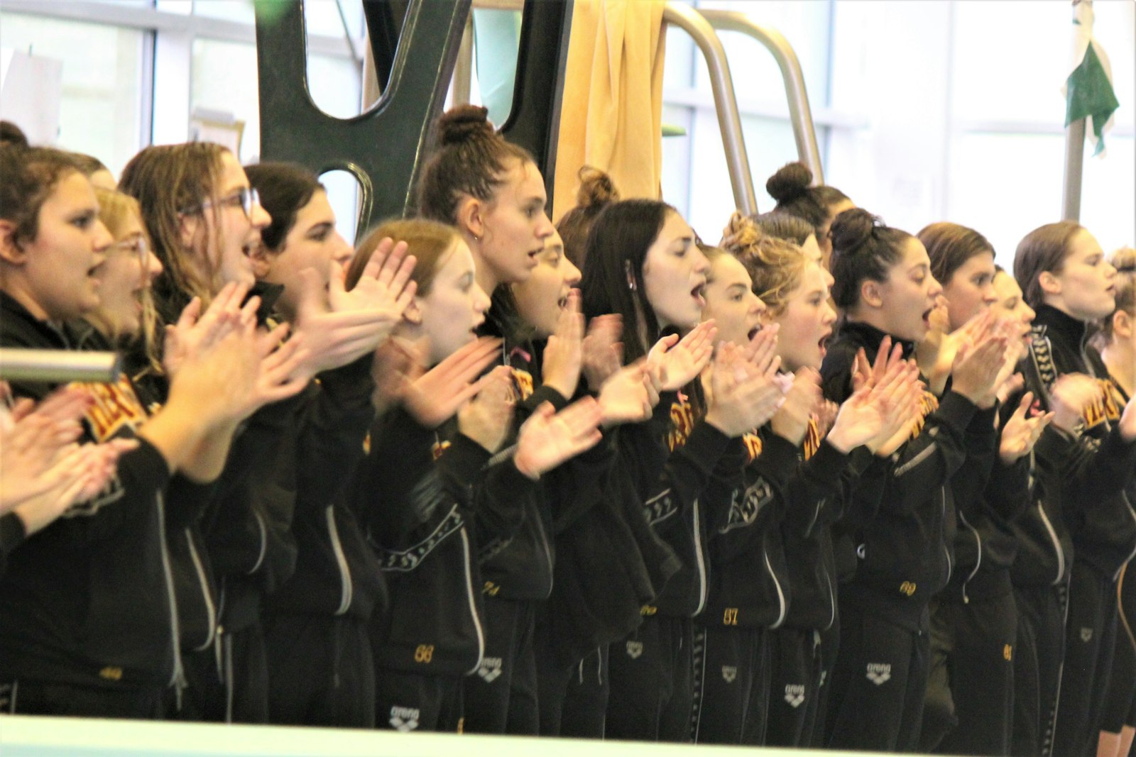 Mercy swimmers line the deck to cheer on their teammates during the meet’s final event, the 400-yard freestyle relay. Not only did the Marlins win that race, they swept first place in the three relay races.