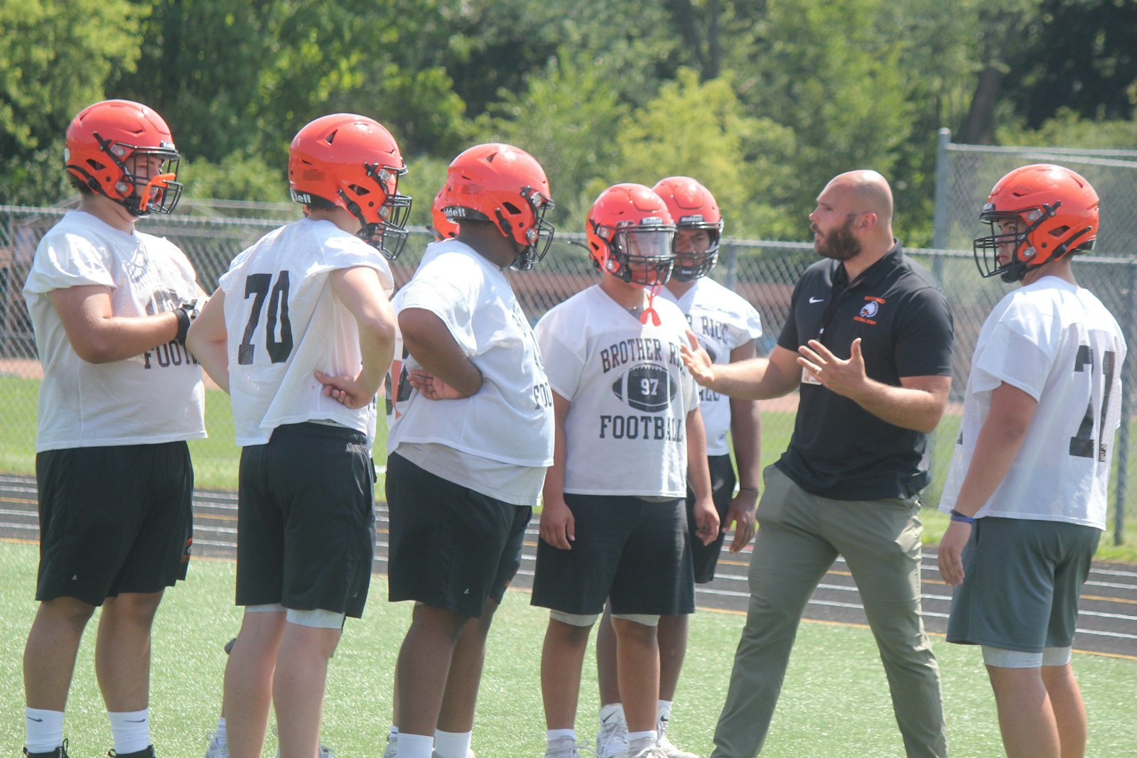 Brother Rice Line Coach Nate Thieker explains the reasoning behind proper technique during a breakout drill.