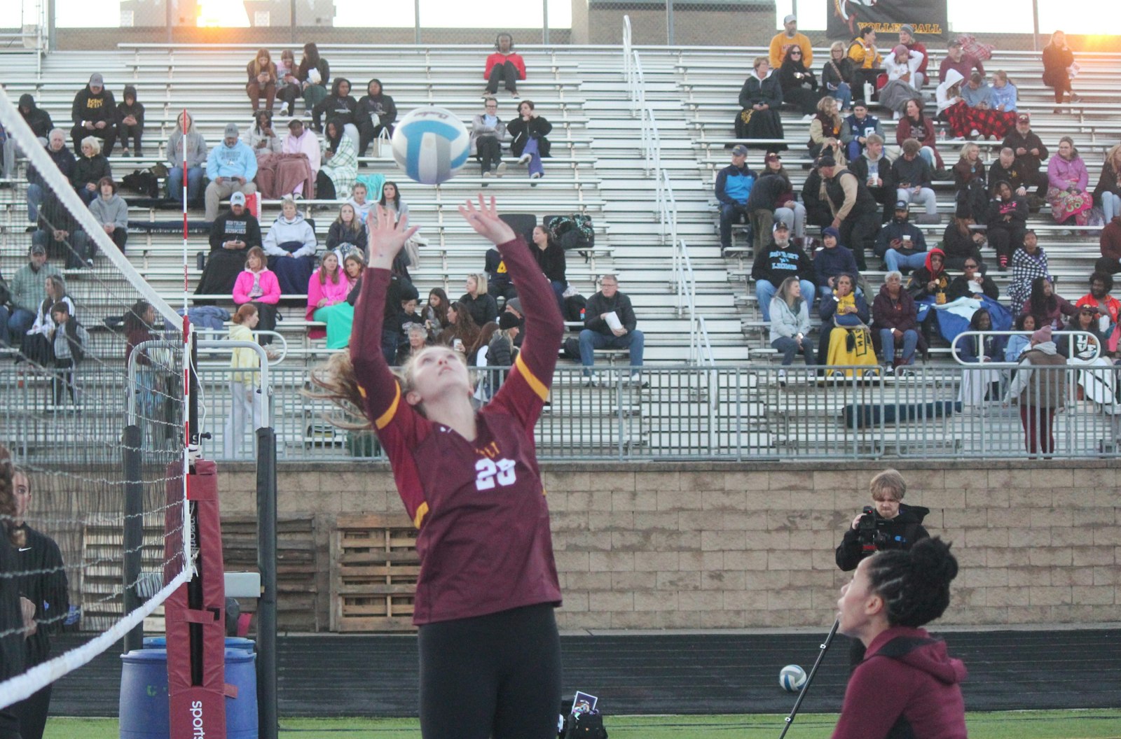 The sun wasn’t the only thing that set during Mercy’s outdoor volleyball scrimmage – here, senior Campbell Flynn sets the ball for a teammate to kill.