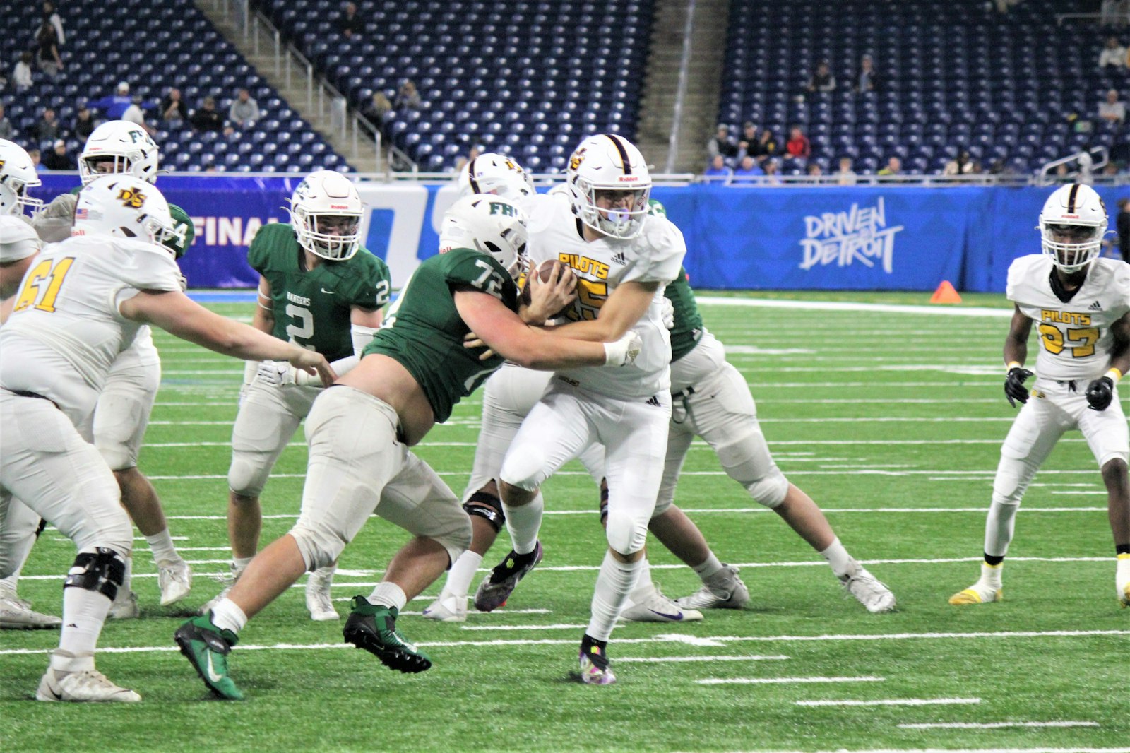 Warren De La Salle quarterback Sante Gasperoni fights for yardage late in the 2022 MHSAA Division 2 state championship game at Ford Field. Although the Pilots won the Catholic League’s Prep Bowl the past two years, it would take two losses by Toledo Central Catholic for De La Salle to earn the invitation to play for a third straight.