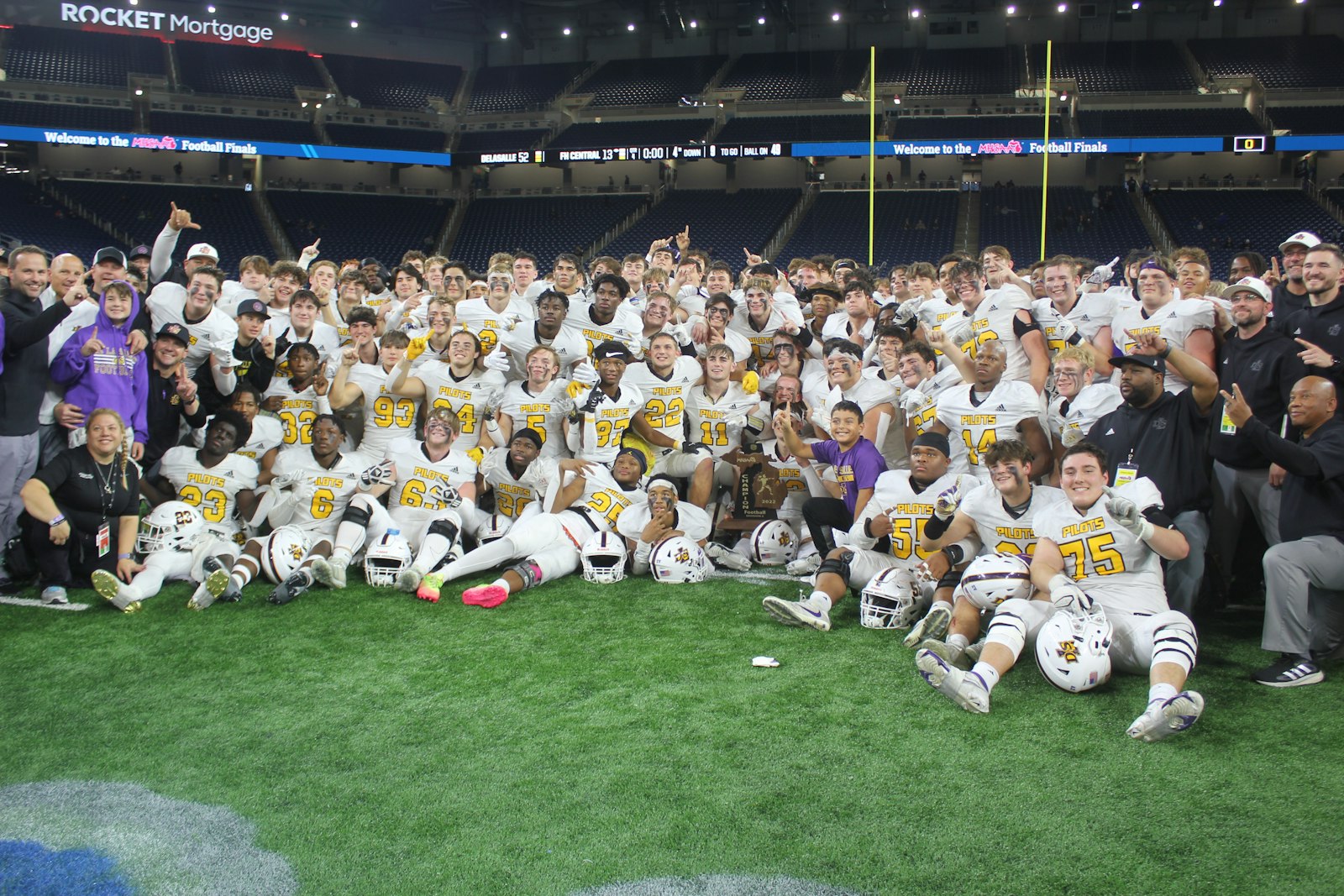 The Warren DeLaSalle football team gathers in the middle of Ford Field to celebrate after winning its second straight state championship, and fifth since 2014.