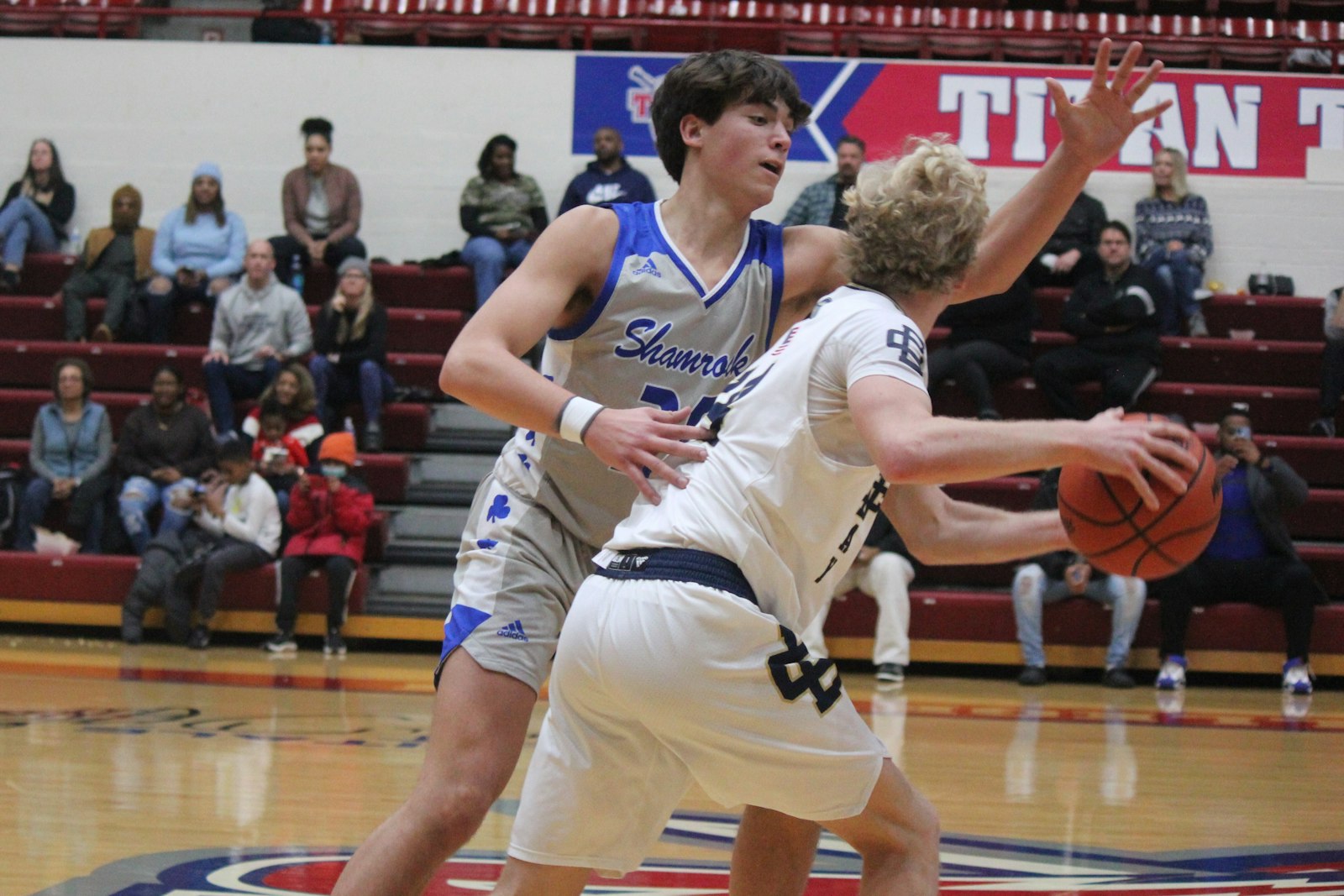 Near midcourt, Catholic Central’s Aaron Rybicki ties up Country Day’s Hunter Riutta with lockdown defensive play.