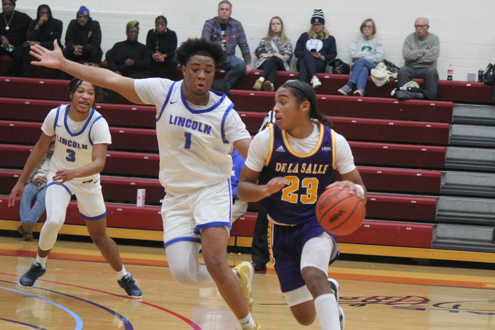 Warren De La Salle sophomore Phoenix Glassnor, driving around Ypsilanti Lincoln’s Jashaun Davis, led all Pilot players with 15 points in a 64-23 win at the University of Detroit Mercy.