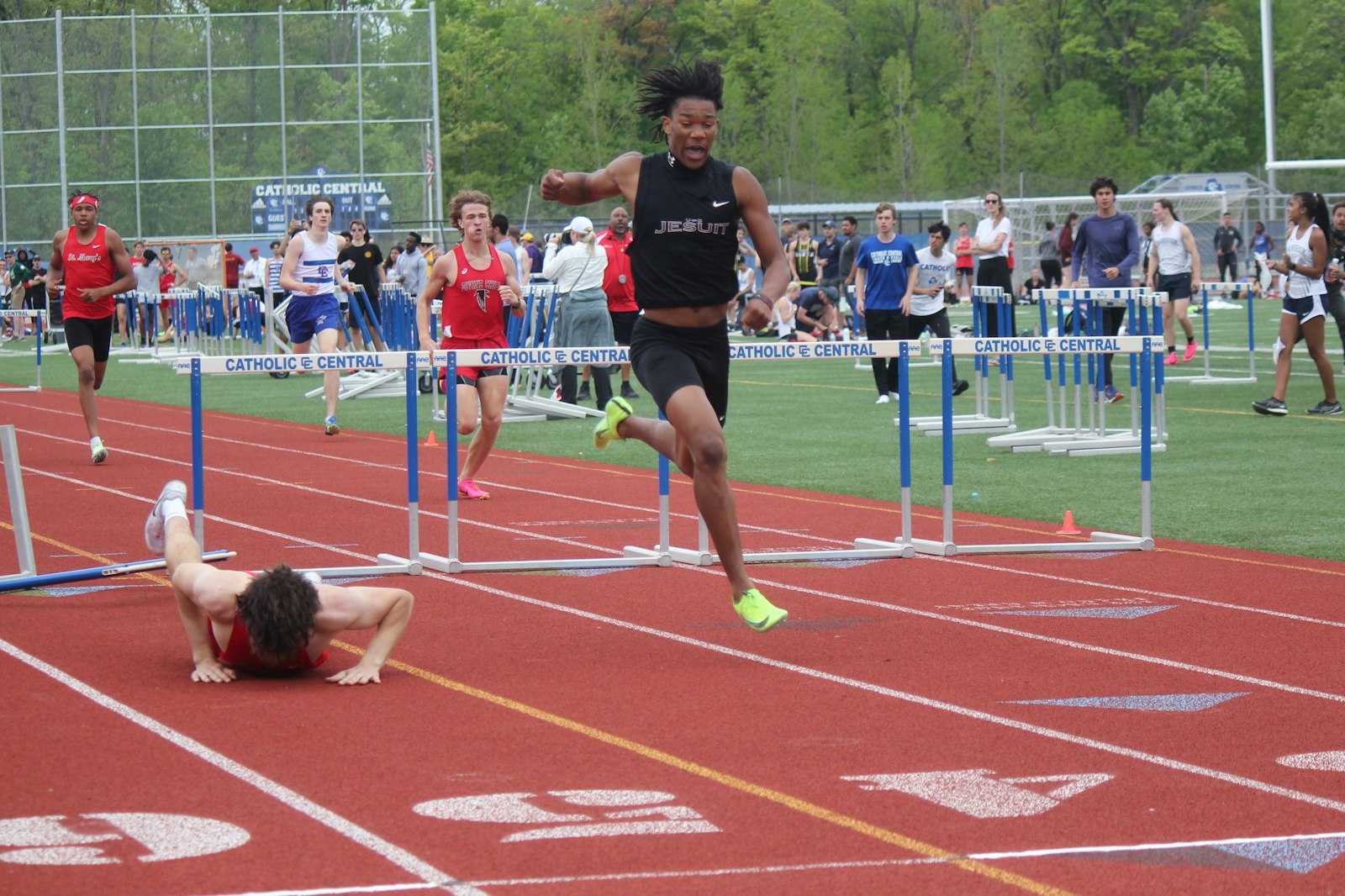 University of Detroit-Jesuit’s Elijah Dotson reacts while approaching the finish line first during the 300-meter hurdles.