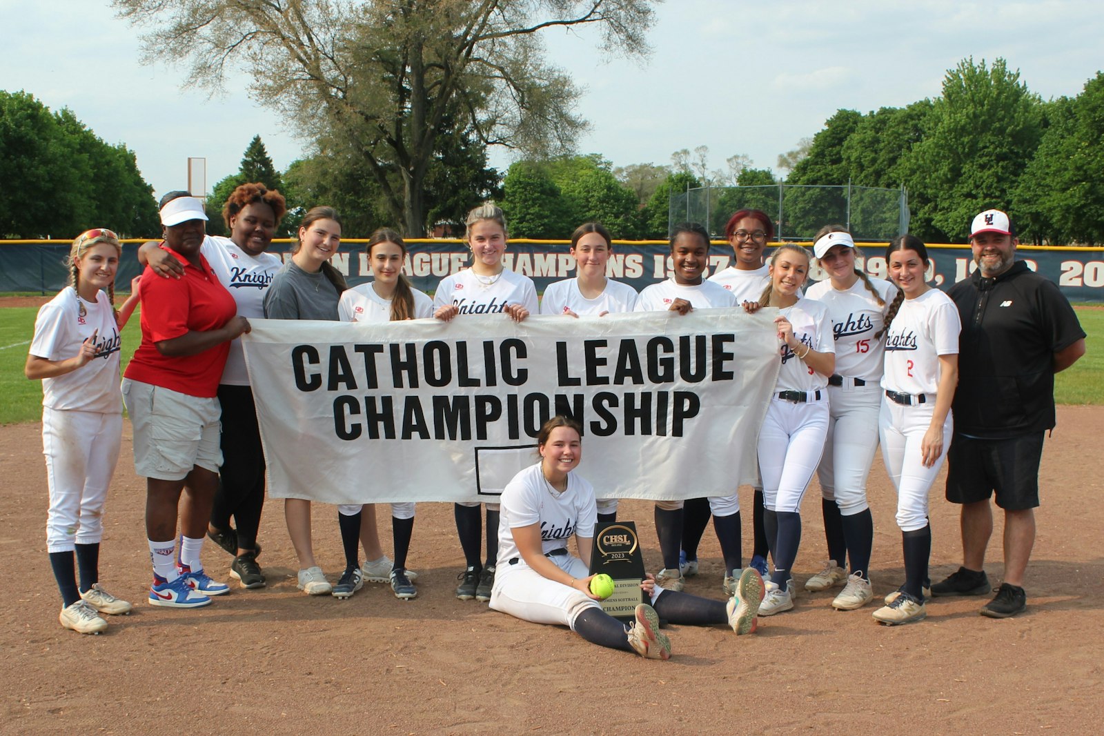 The Grosse Pointe Woods University-Liggett squad basks in the moment after claiming a 9-1 victory over Waterford Our Lady of the Lakes to win the Cardinal Division championship.