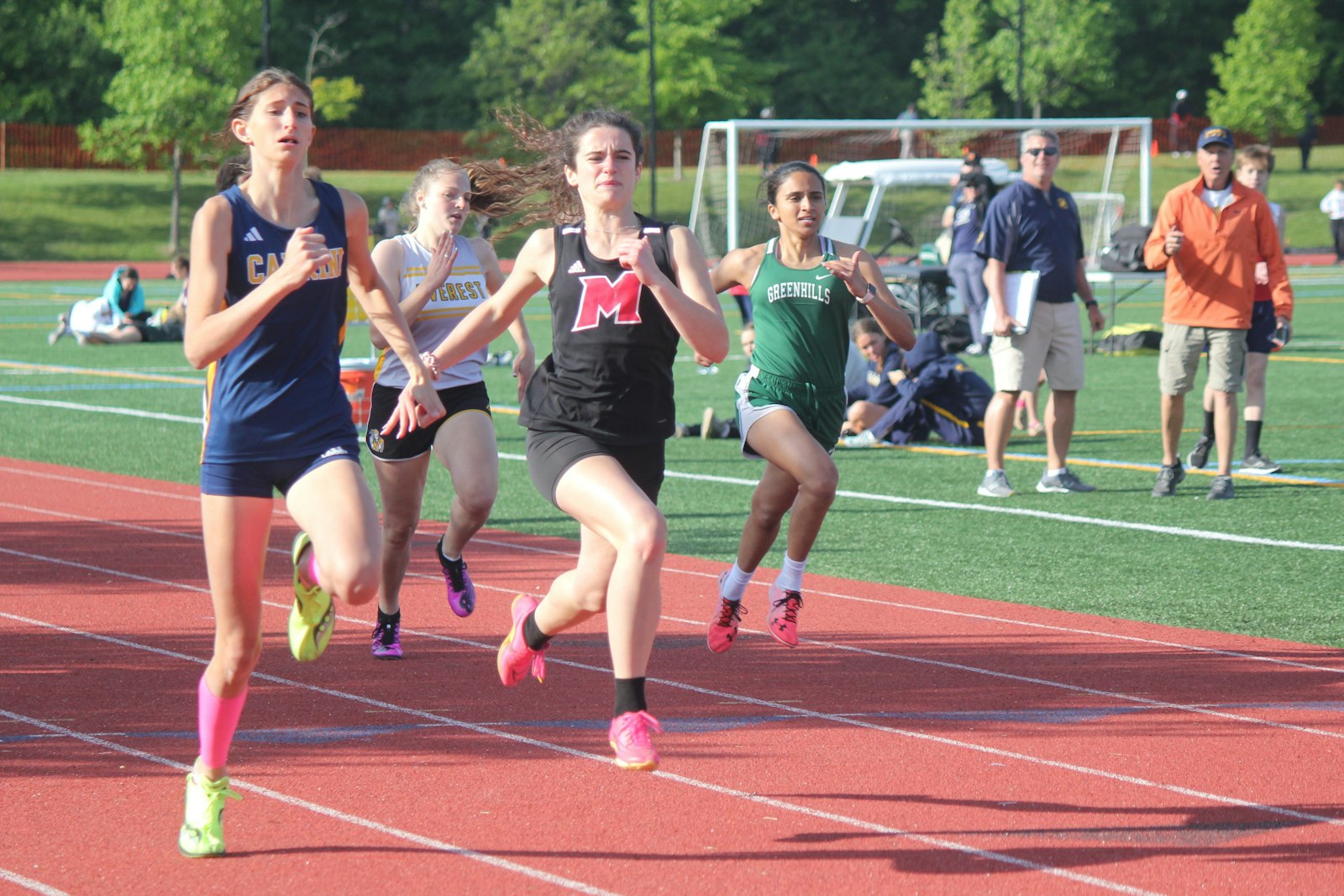 Allen Park Cabrini’s Grace Kendziuk leads the 200 dash down the homestretch, ahead of Everest Collegiate’s Kathleen Thibodeau, Cardinal Mooney’s Gabriela Gashaj and Greenhills’ Navya Ashok.