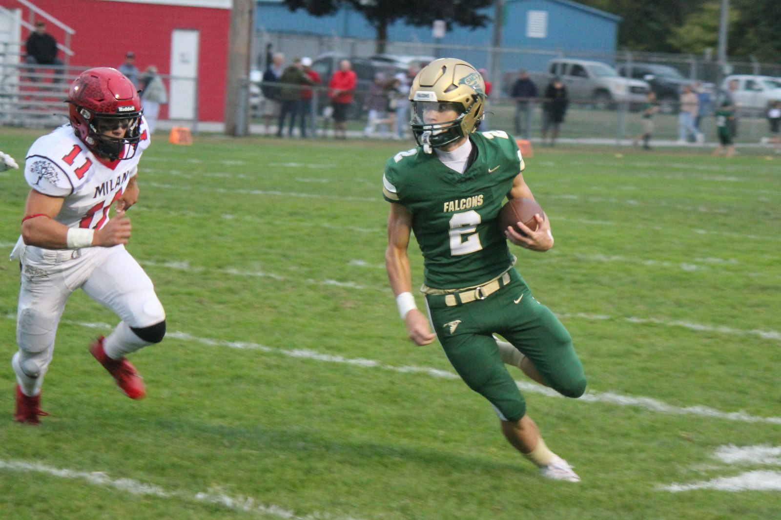 : Pursued by Milan’s C.J. Fairbanks, Ian Foster looks to turn upfield on a quarterback keeper in the first quarter. Foster rushed four times for 33 yards and intercepted a Milan pass while on defense.