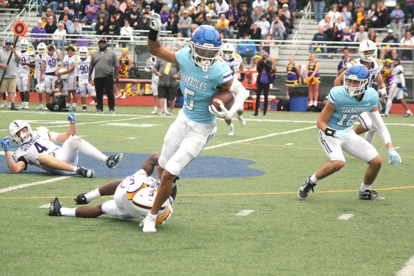 Samson Gash breaks a tackle, converting a routine run play into a 57-yard touchdown in the second quarter of Catholic Central’s homecoming football victory Sept. 29.