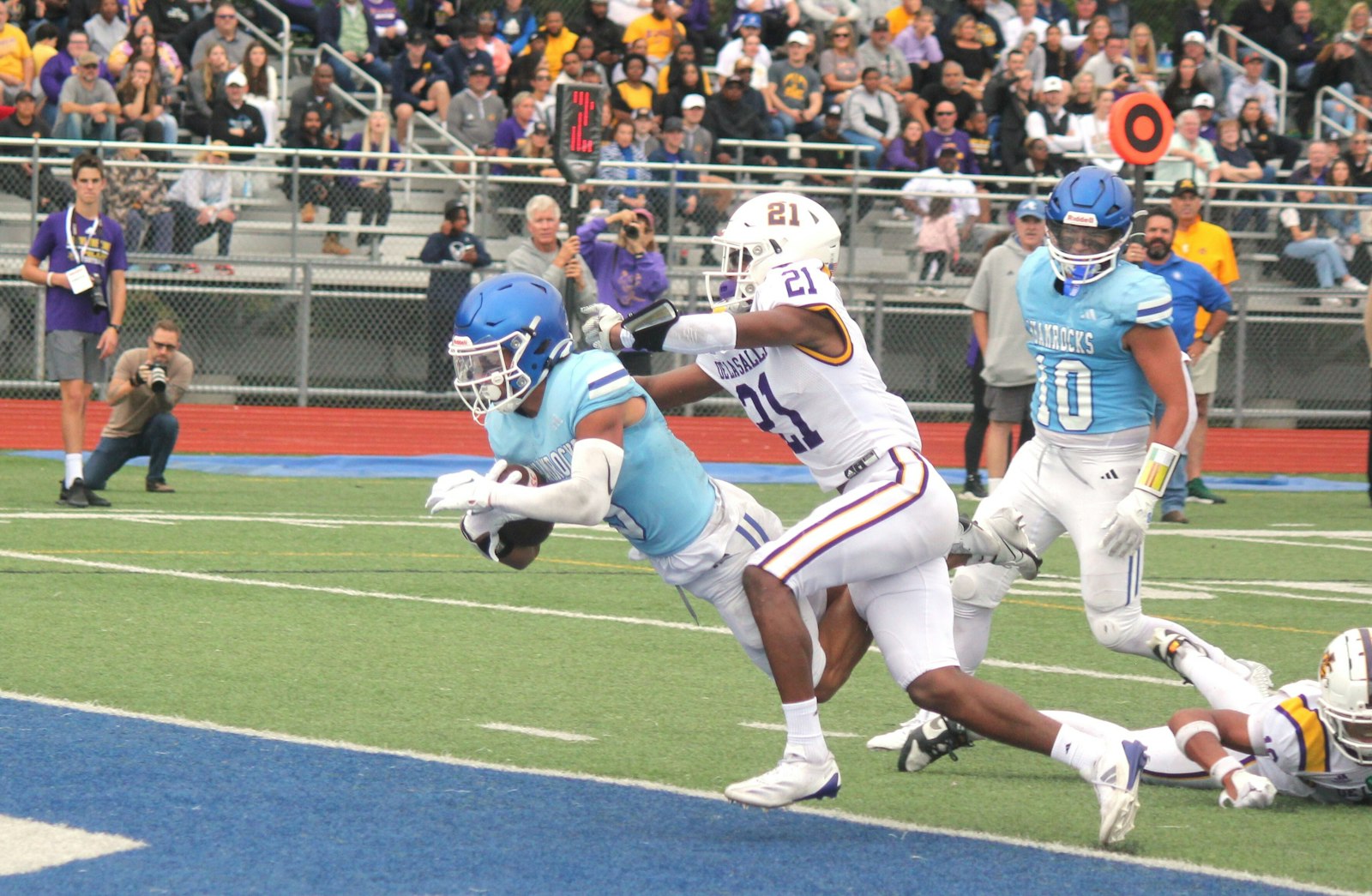 Extending across the goal line while fighting off a tackle, Samson Gash scores on a 12-yard run against Warren De La Salle. Gash had three touchdowns in Catholic Central’s 31-14 Boys’ Bowl win.