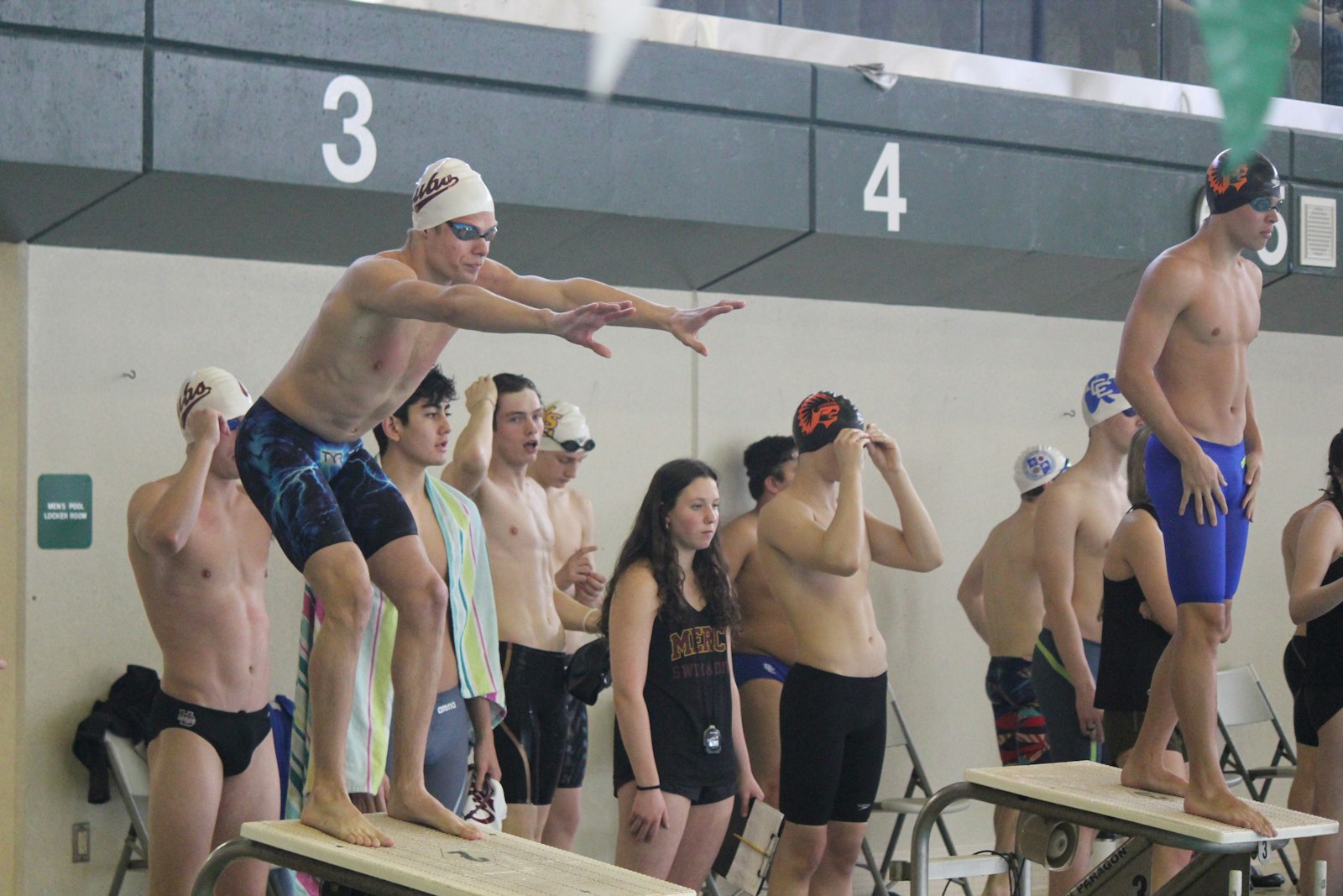 Drew Collins (left, on starting block) was a four-time winner for the Cubs. He placed first in the 200 and 100 freestyle races, and swam on the winning 200 and 400 free relays.