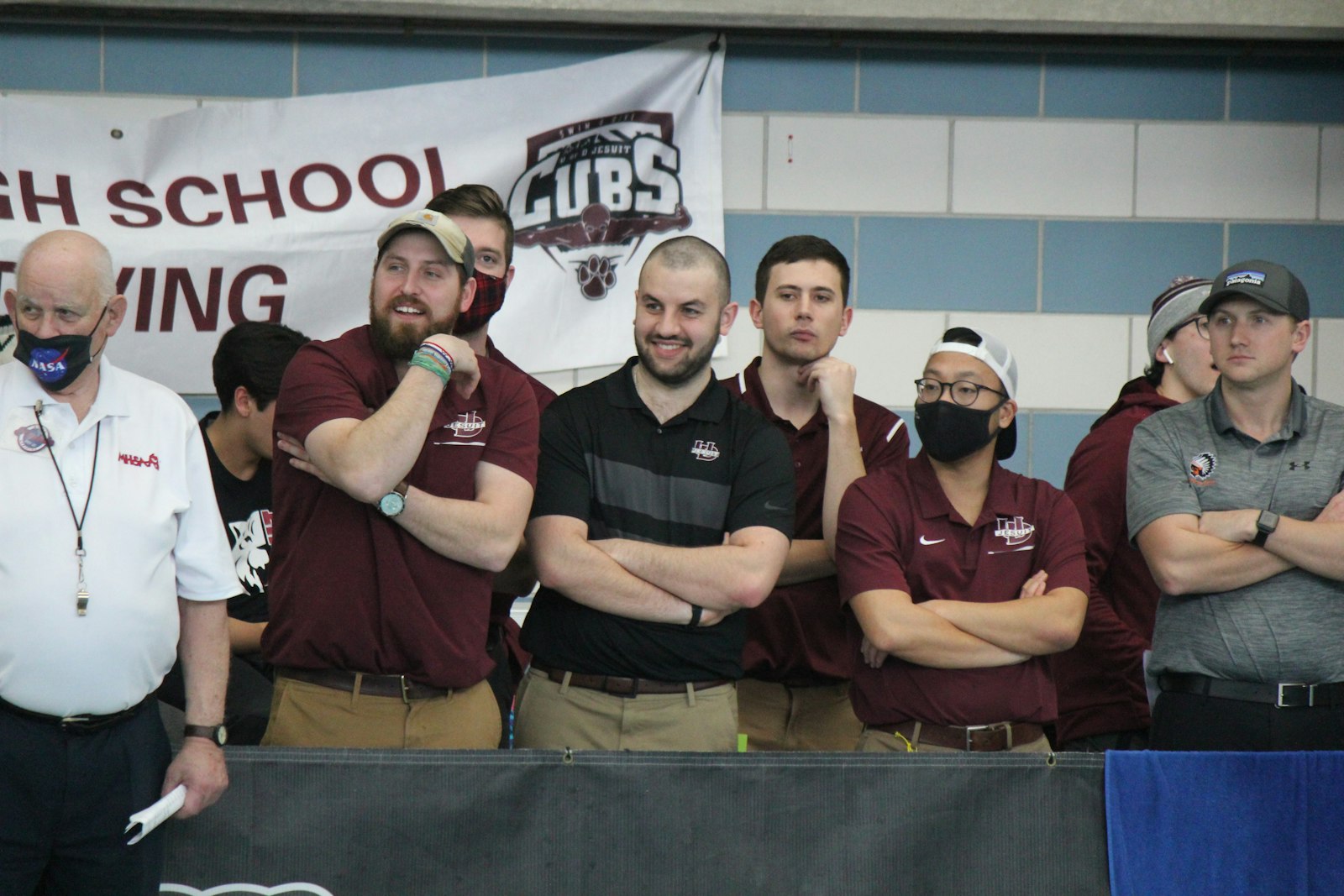 University of Detroit Jesuit coaches look on during the 500 freestyle race. Cub senior Scooby Szuba finished 11th in the event.