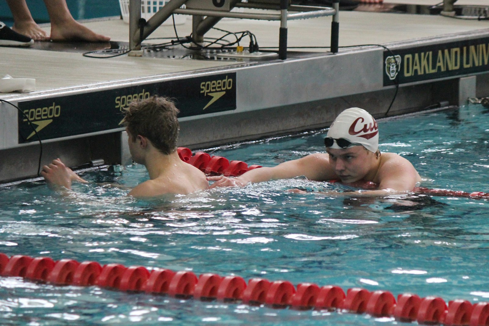 Christian Bouchillon catches his breath after winning the backstroke. To his left is Drew Collins, who placed second. The 1-2 finish in the race was instrumental in helping University of Detroit Jesuit capture runner-up honors at the Division 2 state championships.
