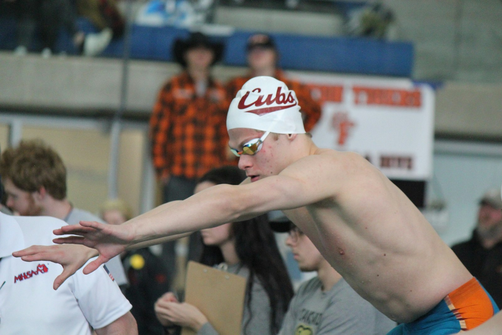 Senior Drew Collins gets ready to enter the water for his leg of the 400 freestyle relay. Earlier, he won the individual medley and finished second in the backstroke.