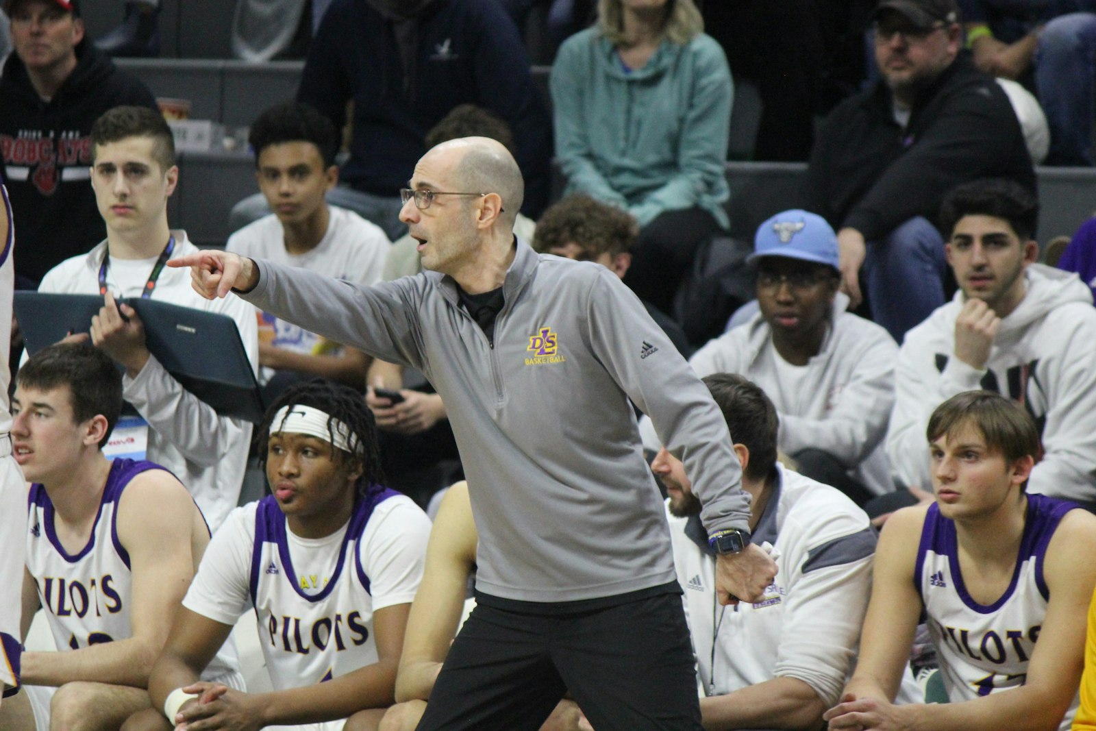 Head coach Gjon Djokaj directs his De La Salle players toward a basketball state championship. The Pilots held off defending champion Grand Blanc behind balanced guard play and a solid fourth-quarter effort.