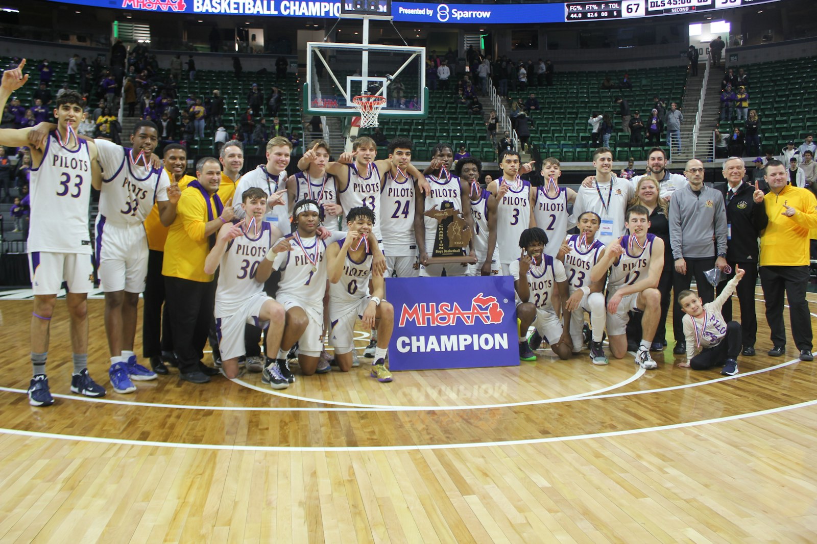 Warren De La Salle celebrates its state title in basketball after defeating defending champion Grand Blanc. It had been 40 years since the last championship game for the Pilots, who finished fourth in the Catholic League this winter.